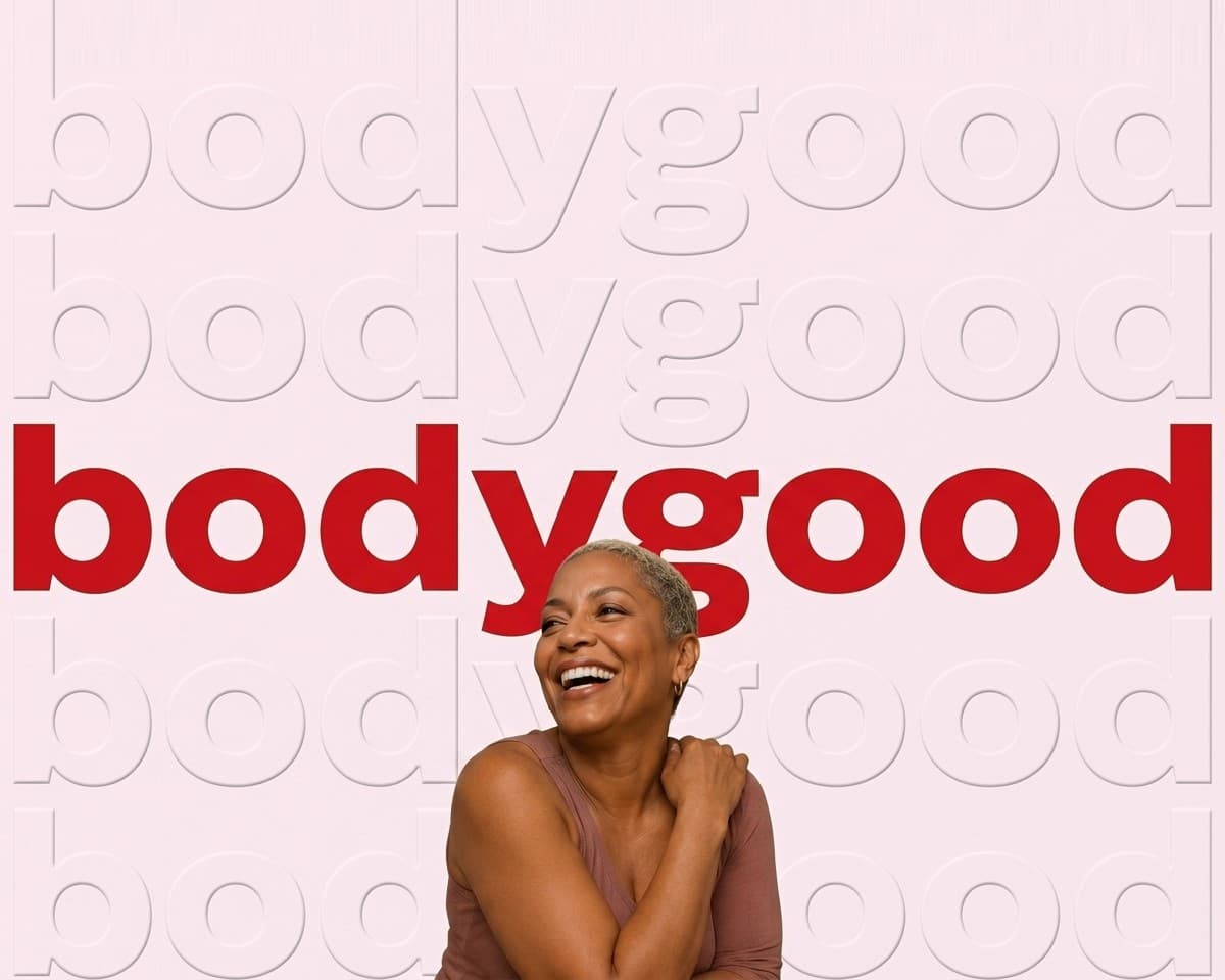 Woman laughing in front of a wall of repeated bodygood wordmarks